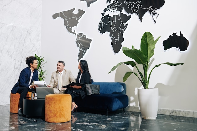 Group of business people having meeting in modern office, discussing plans and ideas