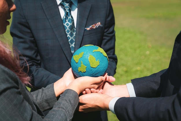 Group of business people hold planet earth globe together gyre