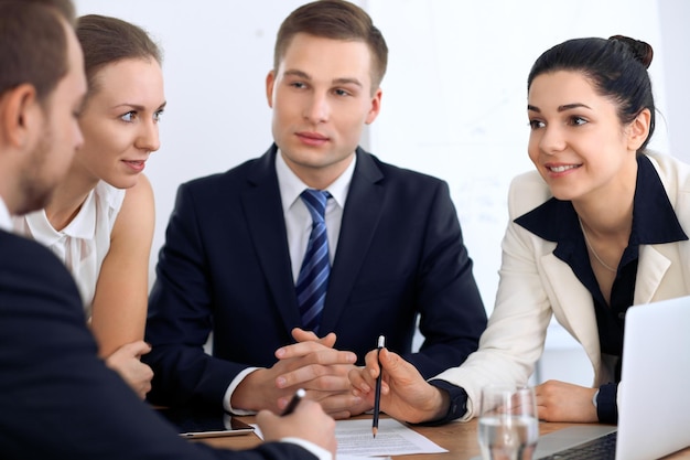 Group of business people and lawyers discussing contract papers