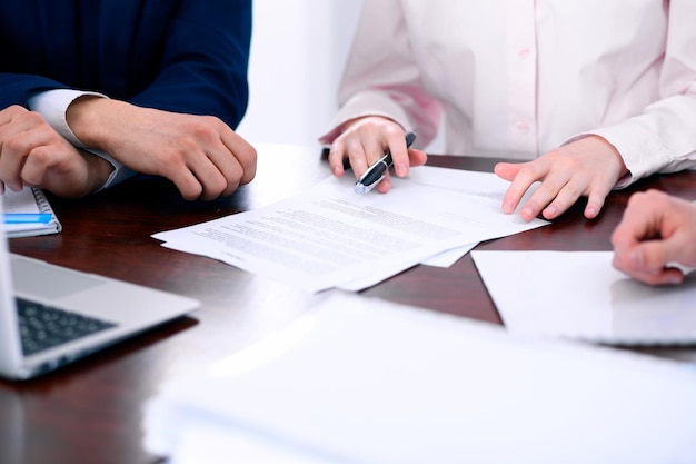 Group of business people and lawyers discussing contract papers