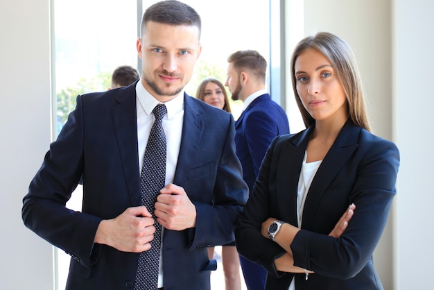 Group of business people at a meeting on the background of office. Focus on a beautiful brunet