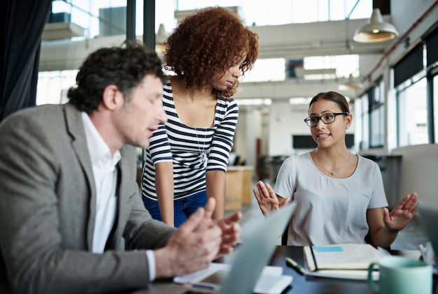 Group business and people in office for meeting with manager as graphic designers for customer feedback Woman man and teamwork for creative company with support or documents for project proposal