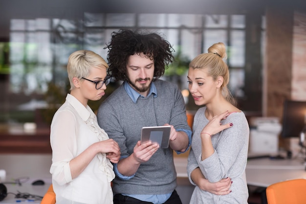 group of business people preparing for next meeting and discussing ideas using digital tablet