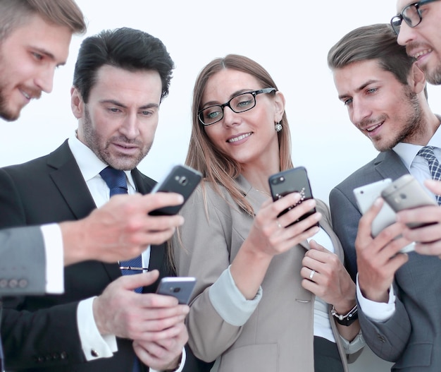 Group of business people reading a message on phones