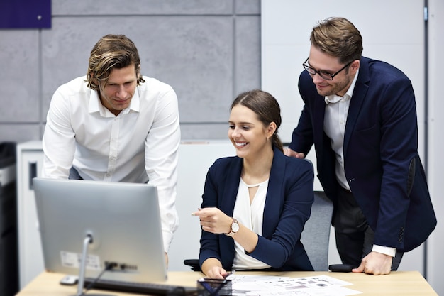 Group of business people sharing ideas in modern office