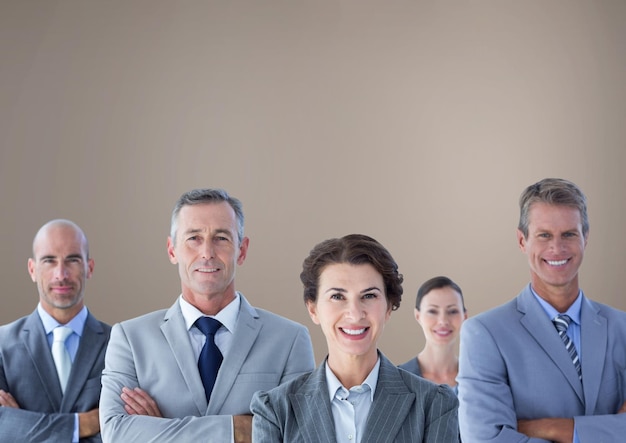 Group of business people standing in front of brown background