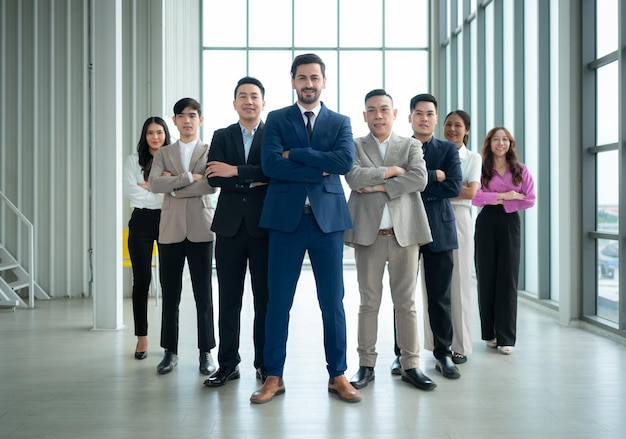 Group of business people standing in line in conference room used for meeting in modern office