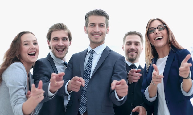 A group of business people standing and pointing at you