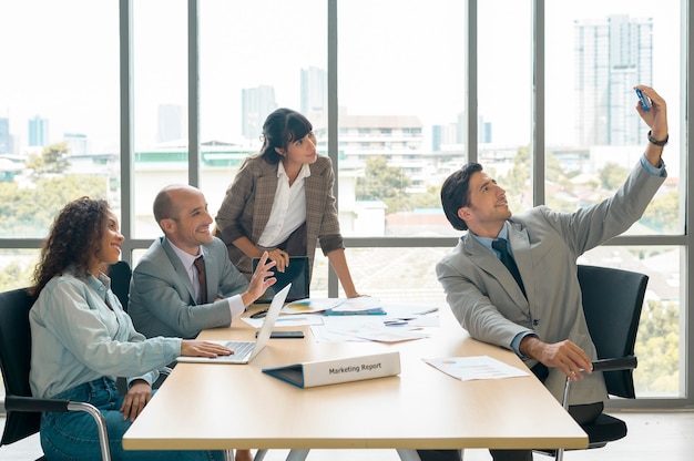 A group of business people taking selfie at office