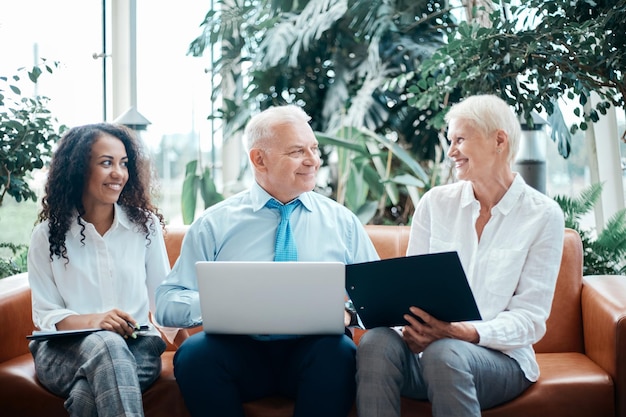 Group of business people using a laptop sitting in the office lobby