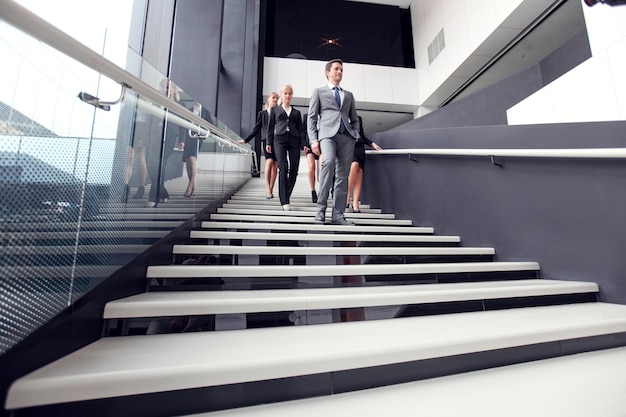 Group of business people walking at stairs