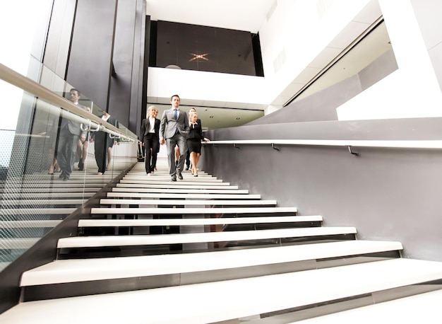 Group of business people walking at stairs