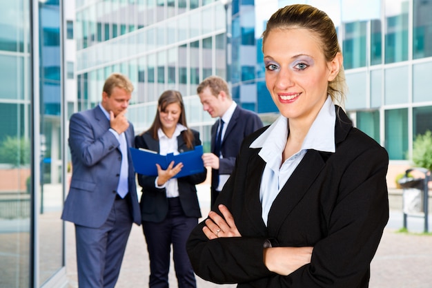 Group of business people with businesswoman leader on foreground 