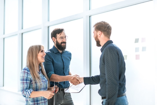 Group of business people with documents standing in the office corridor office weekdays