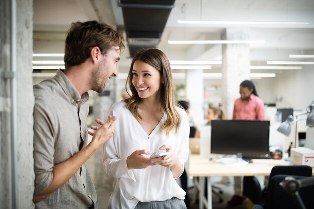 Group of business people working and communicating in office together with colleagues