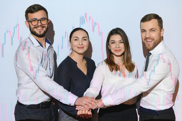 Group of business people working at modern officeTechnical price graph red and blue candlestick chart and stock trading computer screen background Double exposure Traders analyzing data