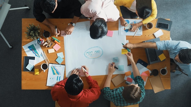 Group of business people writing and making mind map at meeting convocation