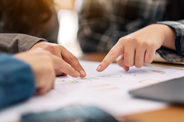 Group of businessman pointing fingers at paperwork while discussing business together in a meeting