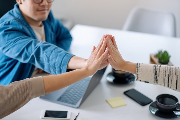 Group of businessman putting their hands together in the meeting