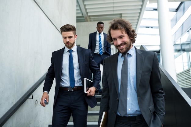 Group of businessmen climbing down stairs