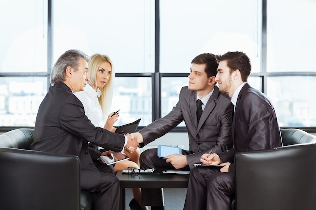 A group of businessmen discussing the policy of the company in t