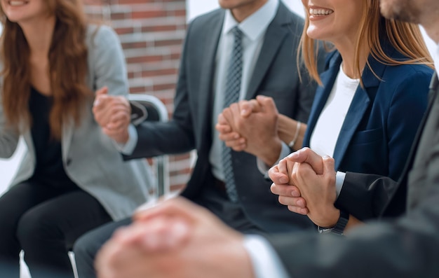 A group of businessmen holding hands in a circle