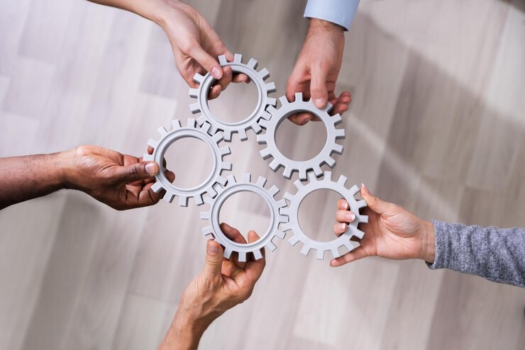 Photo group of businesspeople connecting gears