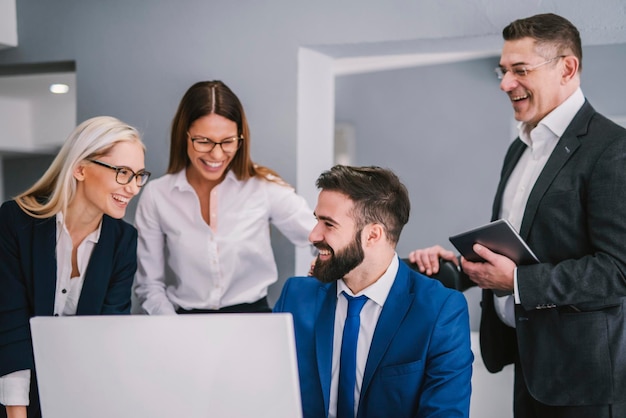 Group of businesspeople helping colleague to finish his work on time