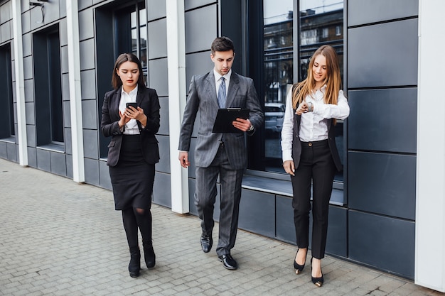 Group of businesspeople walking at street and going to the work