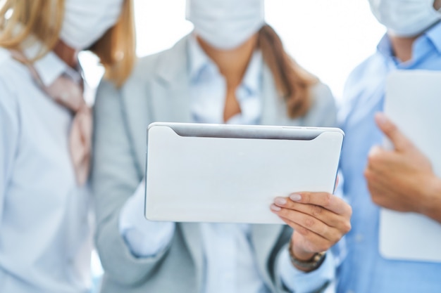 group of businesspeople working in protective masks