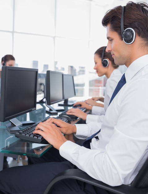 Foto gruppo di impiegati del centro di chiamata che lavorano ai computer