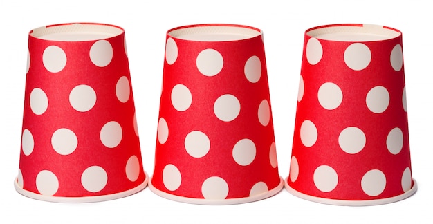 Group of cardboard disposable red dotted cups isolated