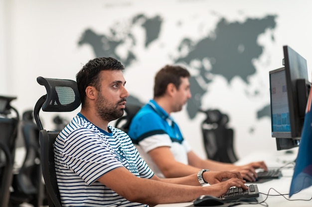 Group of casual businessmen working on a desktop computer in
modern open plan startup office interior. selective focus.
high-quality photo