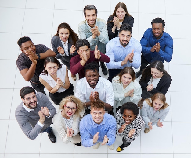 A group of casual young people applauding together