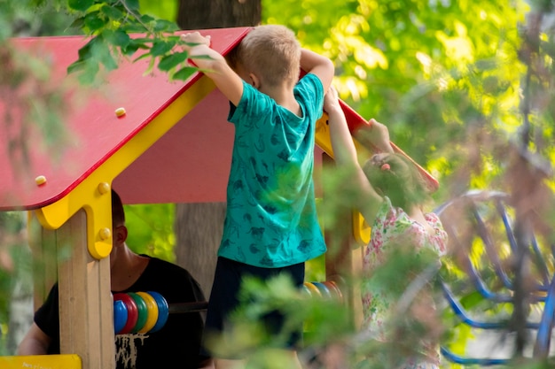 Group of cheerful children do different activities at the playgrounds