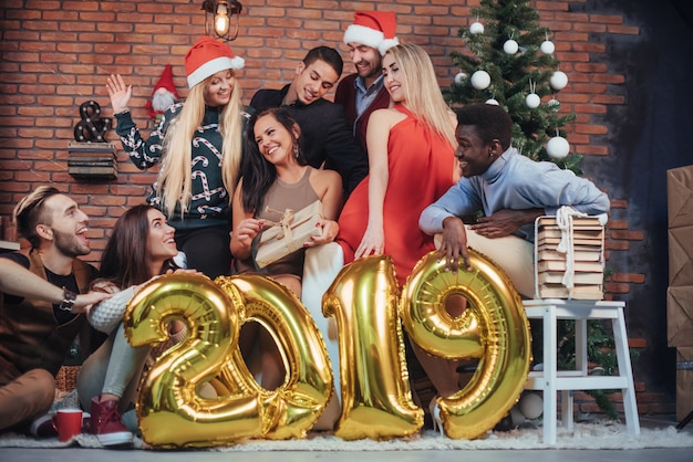 Group of Cheerful old friends communicate with each other. New 2019 Year is coming. Celebrate the new year in a cozy home atmosphere