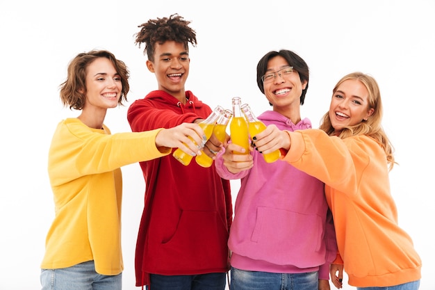 Group of cheerful teenagers isolated, toasting with fizzy drink bottles