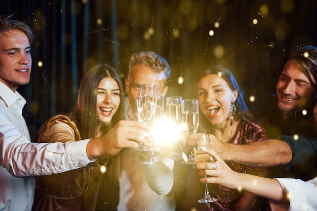 Foto un gruppo di giovani allegri fa festa e festeggia il nuovo anno al chiuso.