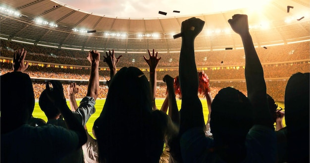 Group of cheering fans watch a sport championship on stadium Their team wins and everybody are celebrating this event People are dressed in casual cloth