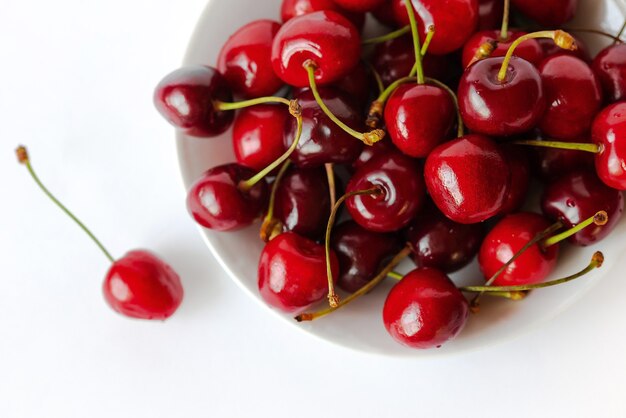 Group of cherries on white plate