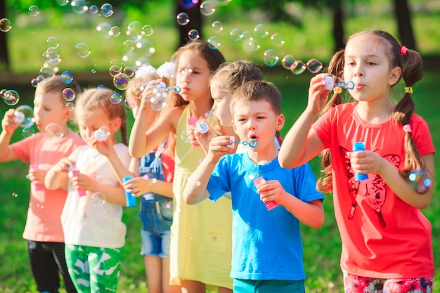 Group of children blowing soap bubbles