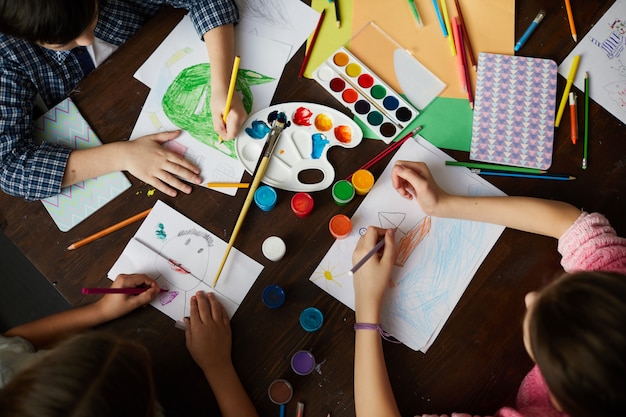 Group of Children Drawing Above View