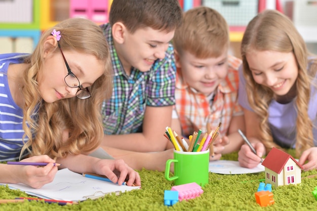 Group of children drawing with pencils