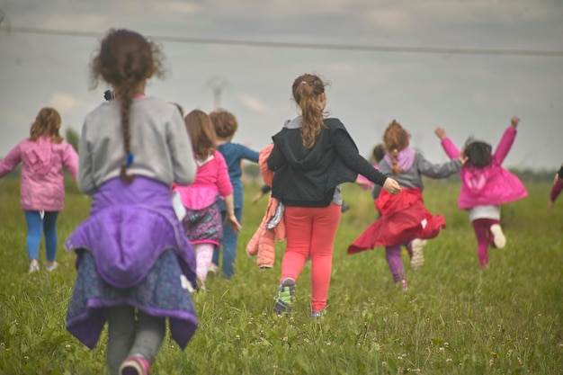 Group of children play in the meadow