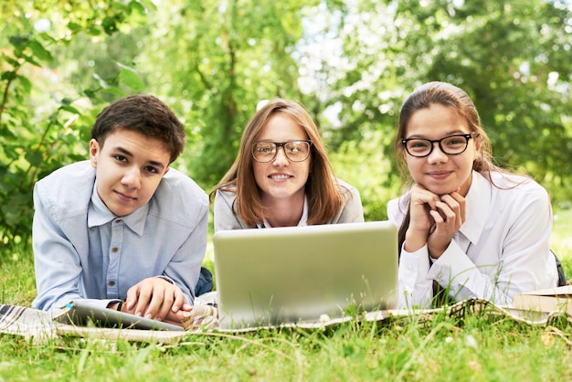 Group of Children Studying on Green Lawn