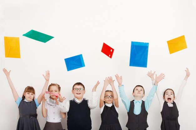 A group of children in uniforms in the Studio on a white background. Education, fashion, the concept of friendship.