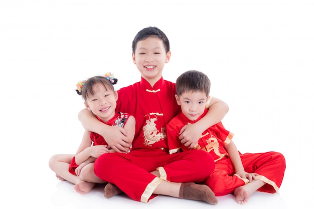 Group of children wearing chinese traditional costume sitting on the floor 