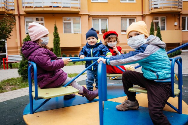 도시 운동장에서 의료용 마스크를 쓴 어린이 그룹
