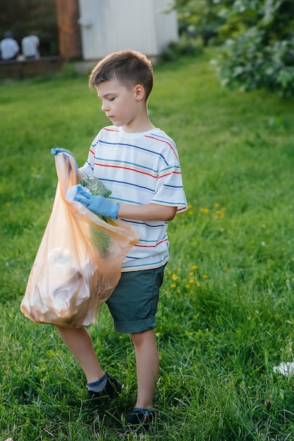 A group of children with their parents are engaged in garbage collection.


