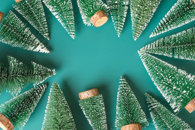 Group of christmas tree lay on green backgorund top view